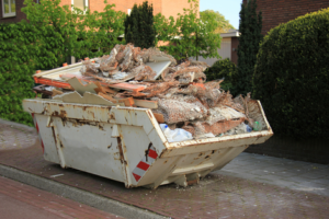 domestic skip at roadside of residential property full off bricks and rubble from house renovation